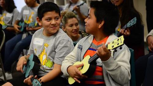 Kids playing ukulele at the day of service