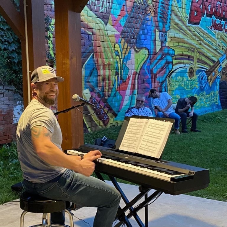 a man plays keyboard at brighton music center's open mic night